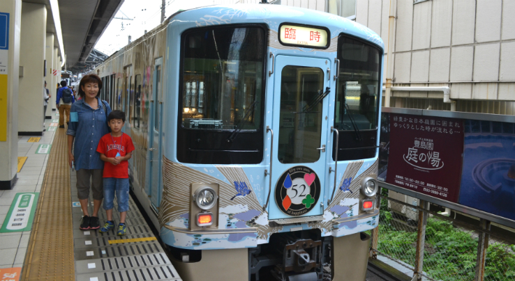 初めて乗るレストラン列車と記念撮影をする池戸さん親子