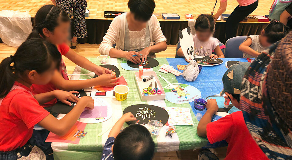 Children enjoying collage work on their Uchiwa fans