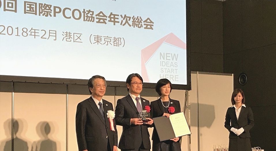 JCS President Chikanami in a commemorative photograph with the plaque given to him (center)