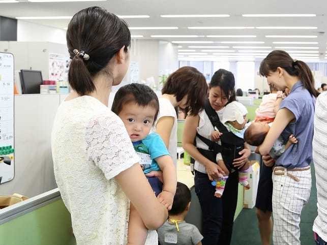 Mothers visiting the office with their young children.